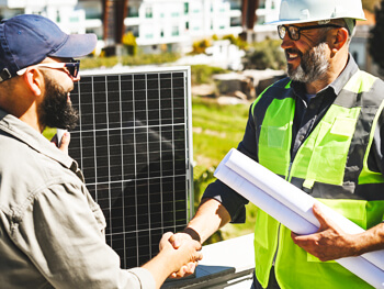 Two men shaking hands on a job site