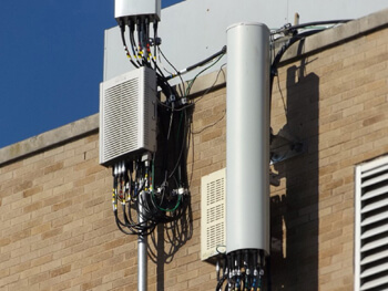 External view of DAS equipment on the side of a brick building